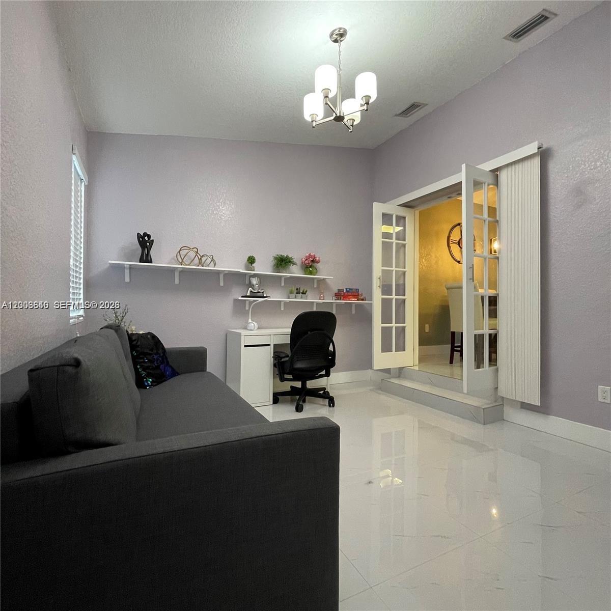 1380 Southwest 11th Street, Unit 1 Miami, FL 33135 - Photo 8 of 20 a living room with furniture and a chandelier