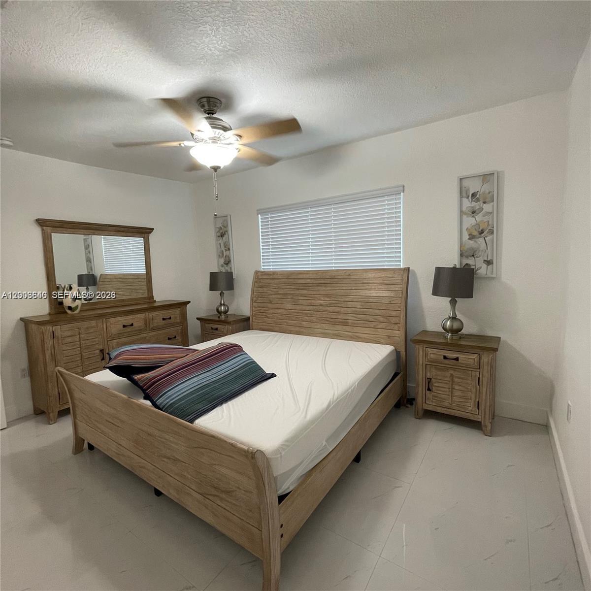 1380 Southwest 11th Street, Unit 1 Miami, FL 33135 - Photo 9 of 20 a bedroom with furniture and a flat screen tv