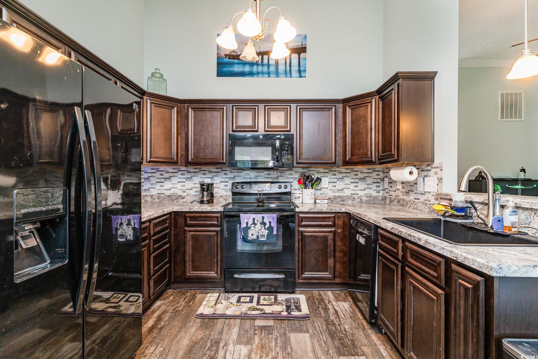 2432 Summerhaven Loop Conway, SC 29527 - Photo 16 of 40 Kitchen featuring hanging light fixtures, black ap