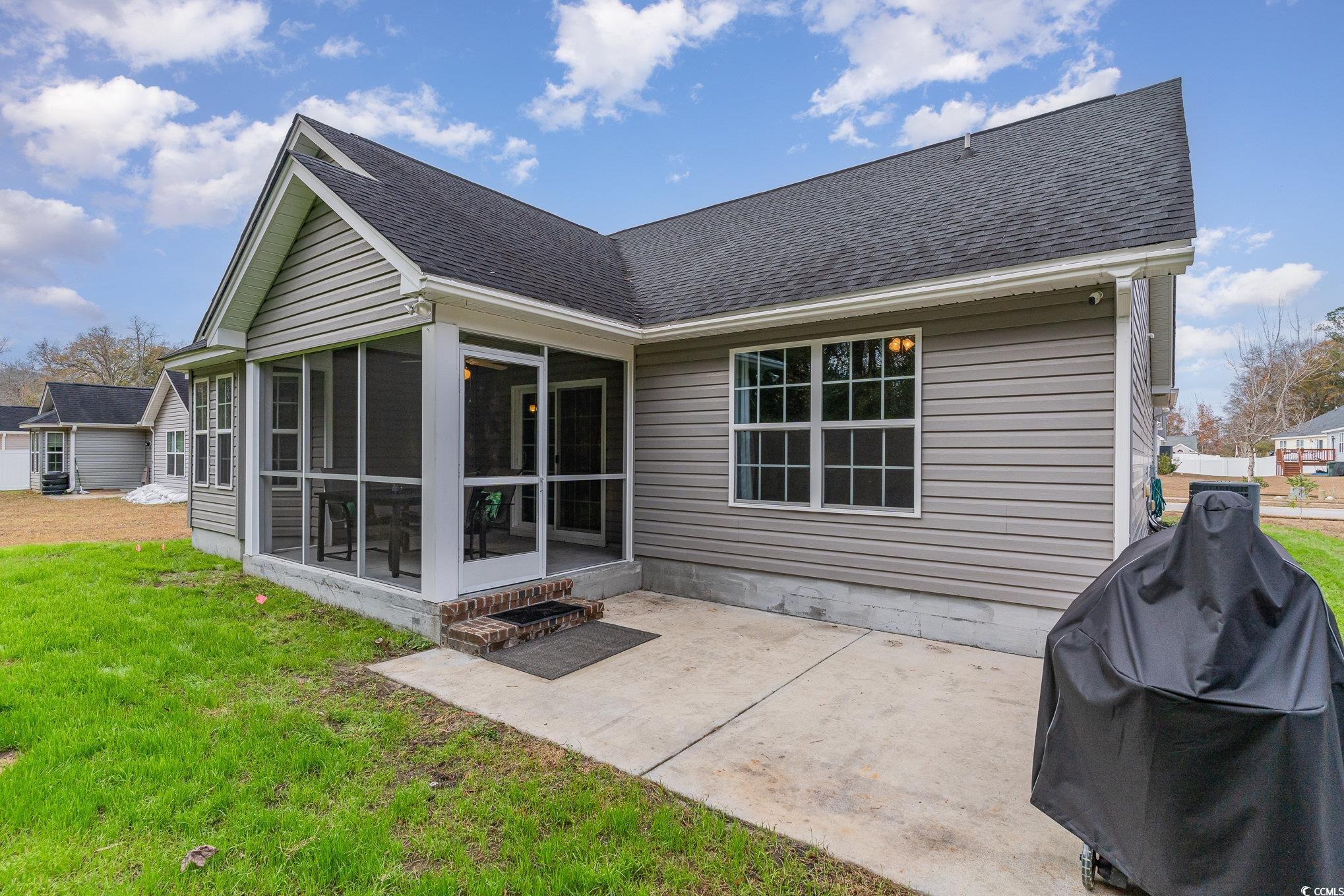 2432 Summerhaven Loop Conway, SC 29527 - Photo 31 of 40 Back of house featuring a lawn, a patio area, and