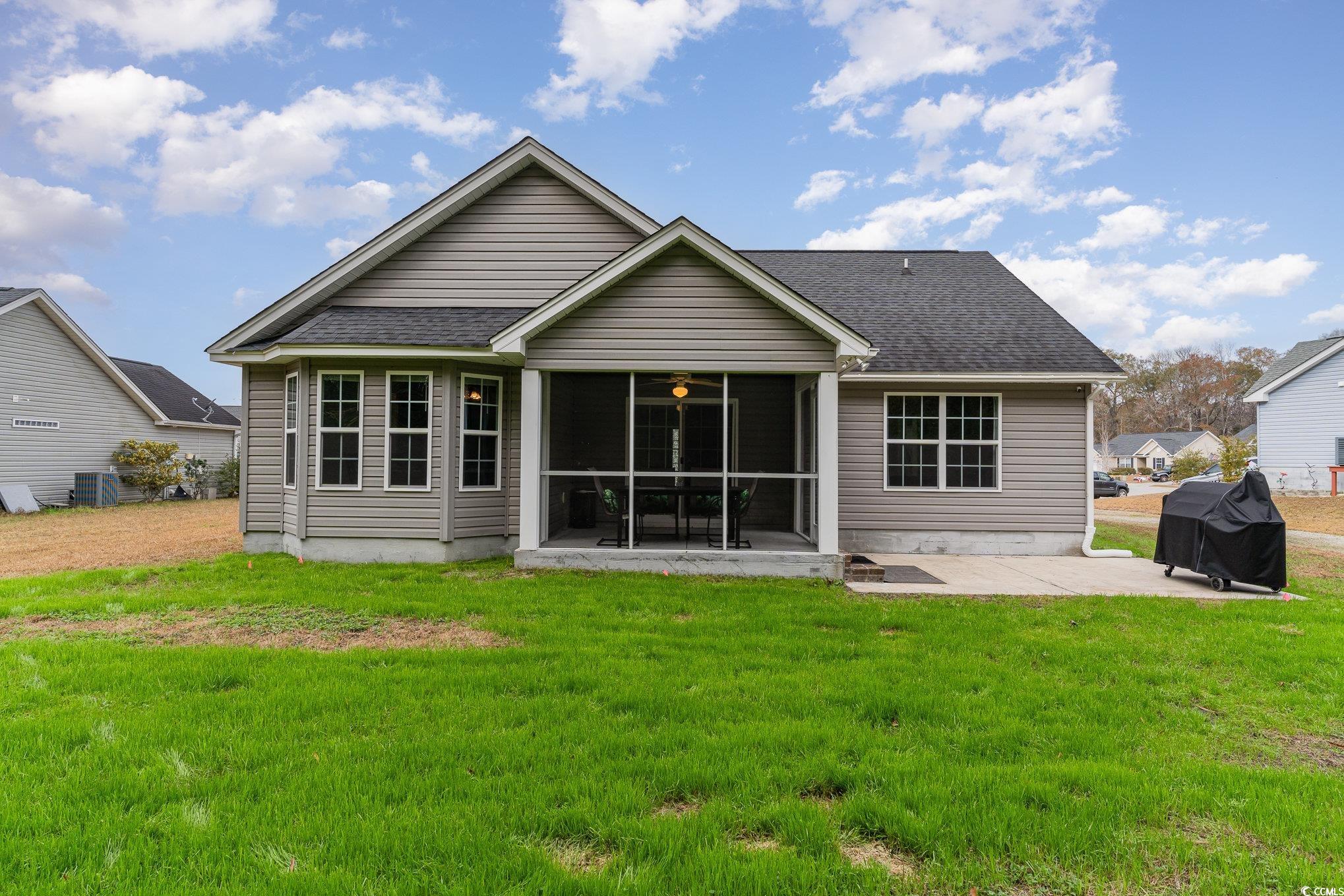 2432 Summerhaven Loop Conway, SC 29527 - Photo 32 of 40 Back of house with a sunroom, a patio, and a lawn