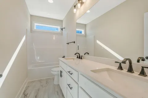 a bathroom with a sink a toilet and tub