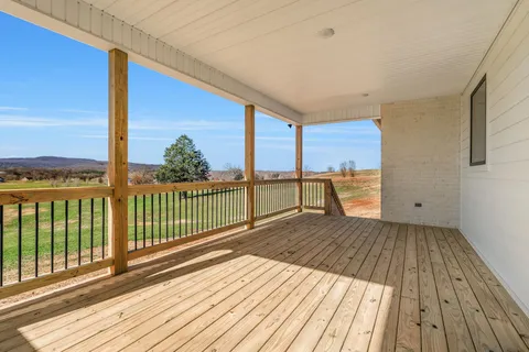a view of a balcony with wooden floor
