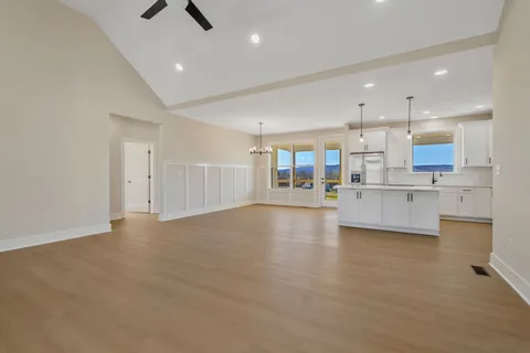 a view of a kitchen with kitchen island and stainless steel appliances