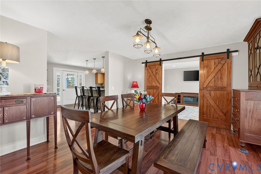 7844 Olivet Church Road New Kent, VA 23124 - Photo 18 of 43 a view of a dining room with furniture and wooden floor