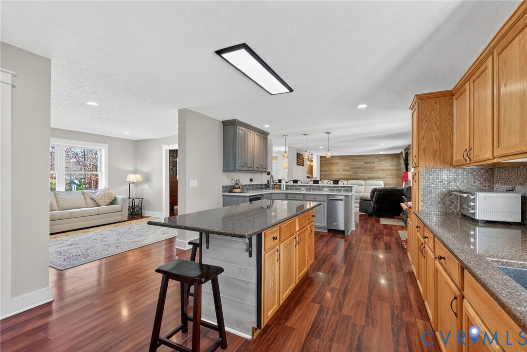 7844 Olivet Church Road New Kent, VA 23124 - Photo 22 of 43 a kitchen with counter top space a sink wooden floor and stainless steel appliances