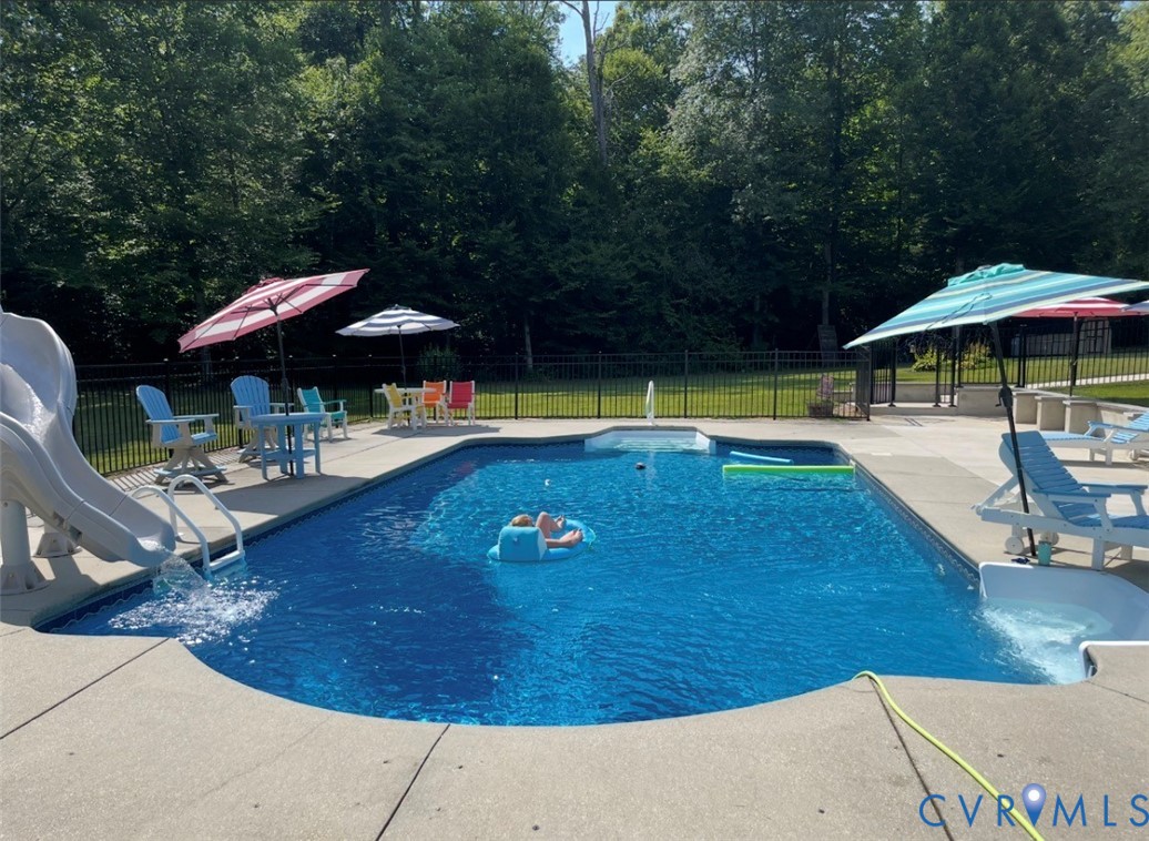 7844 Olivet Church Road New Kent, VA 23124 - Photo 7 of 43 a view of swimming pool with lounge chair under an umbrella