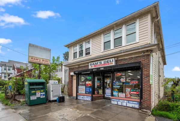 a front view of a multi story building with retail shops