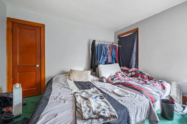 a bedroom with a bed and cabinets