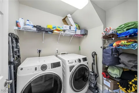 a utility room with dryer washer and a wooden floor