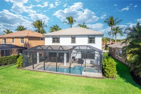 a front view of a house with a garden and yard