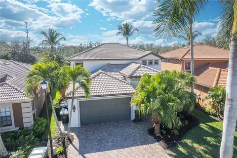 a view of a house with a yard and potted plants