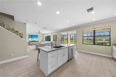 a kitchen with granite countertop a sink and a stove