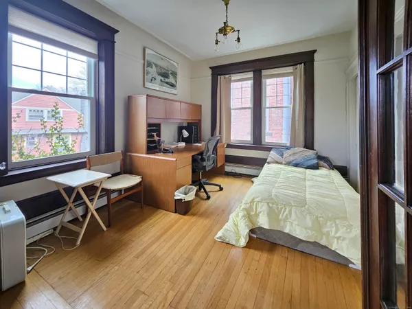 a bedroom with furniture and a window