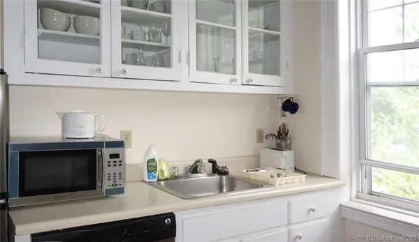 a sink with a stove and microwave