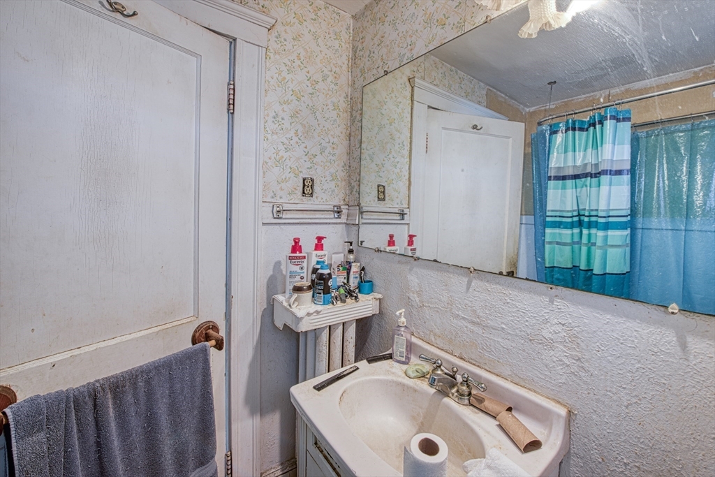 3 Crescent Road Needham, MA 02494 - Photo 15 of 15 a bathroom with a sink vanity and a mirror