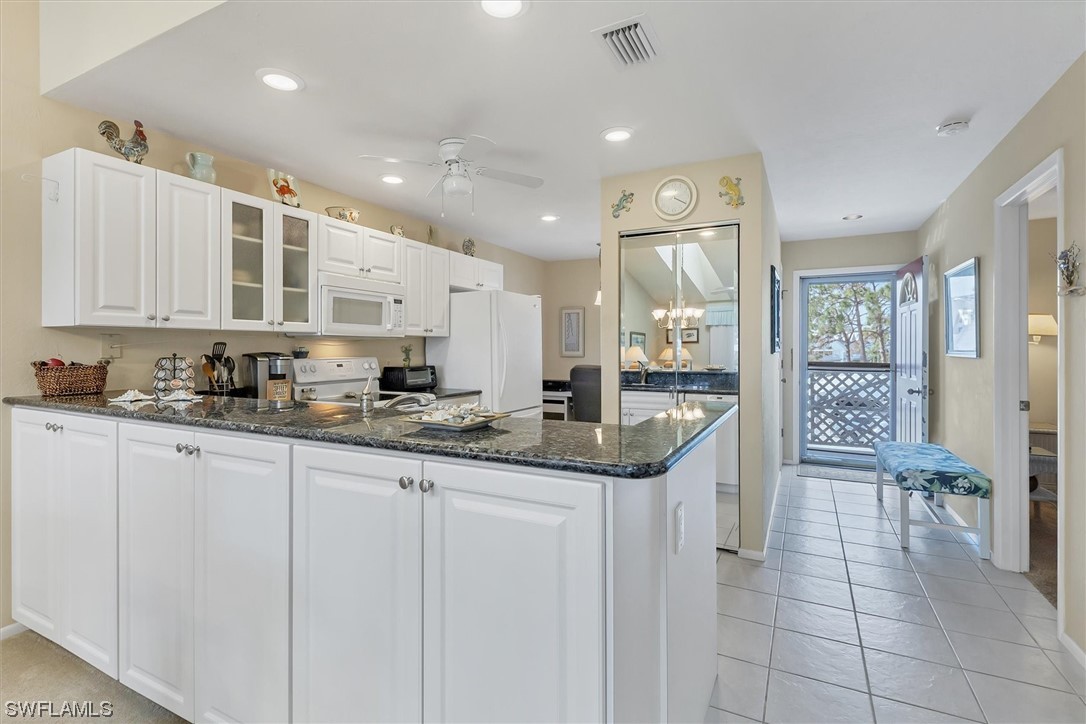 6800 Placida Road, Unit 2002 Englewood, FL 34224 - Photo 11 of 25 a kitchen with granite countertop a sink and cabinets