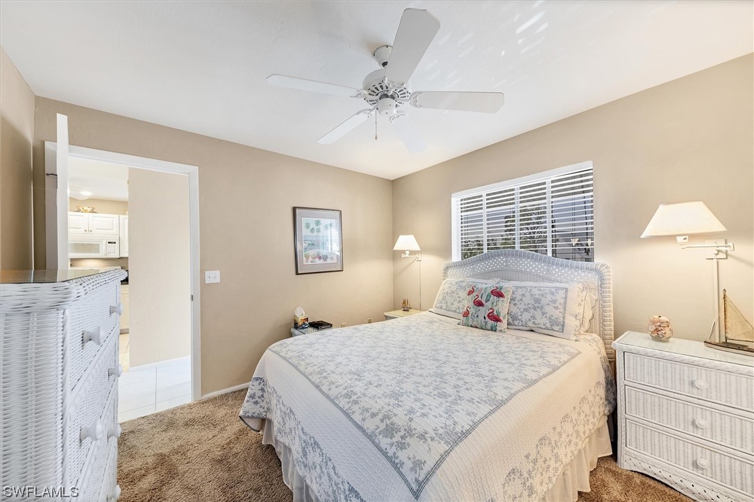 6800 Placida Road, Unit 2002 Englewood, FL 34224 - Photo 14 of 25 a bedroom with a large bed and a chandelier