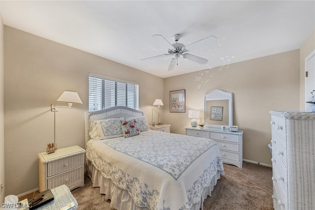 6800 Placida Road, Unit 2002 Englewood, FL 34224 - Photo 15 of 25 a bedroom with a large bed and a chandelier