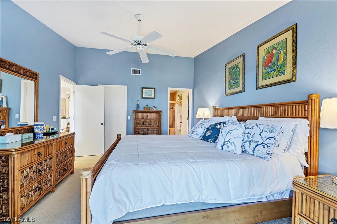 6800 Placida Road, Unit 2002 Englewood, FL 34224 - Photo 17 of 25 a bedroom with a bed and a chandelier