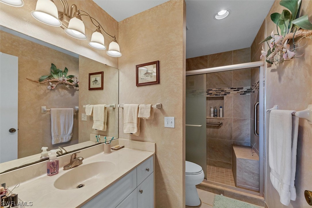 6800 Placida Road, Unit 2002 Englewood, FL 34224 - Photo 19 of 25 a bathroom with a sink toilet and shower
