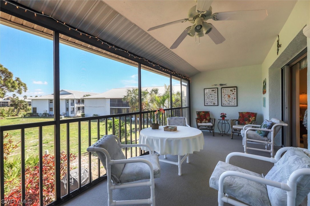6800 Placida Road, Unit 2002 Englewood, FL 34224 - Photo 21 of 25 a living room with furniture and a floor to ceiling window