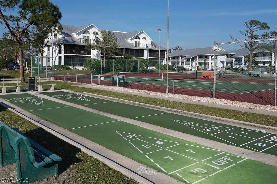 6800 Placida Road, Unit 2002 Englewood, FL 34224 - Photo 25 of 25 a view of a tennis ground with large trees