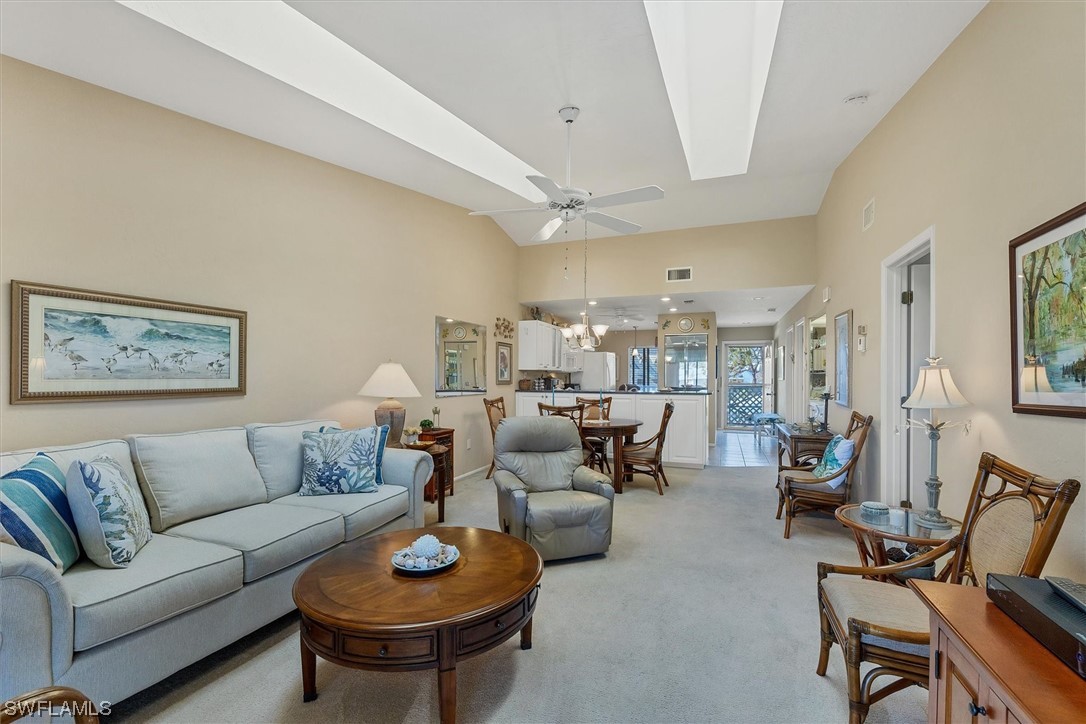 6800 Placida Road, Unit 2002 Englewood, FL 34224 - Photo 8 of 25 a living room with furniture a rug and a chandelier