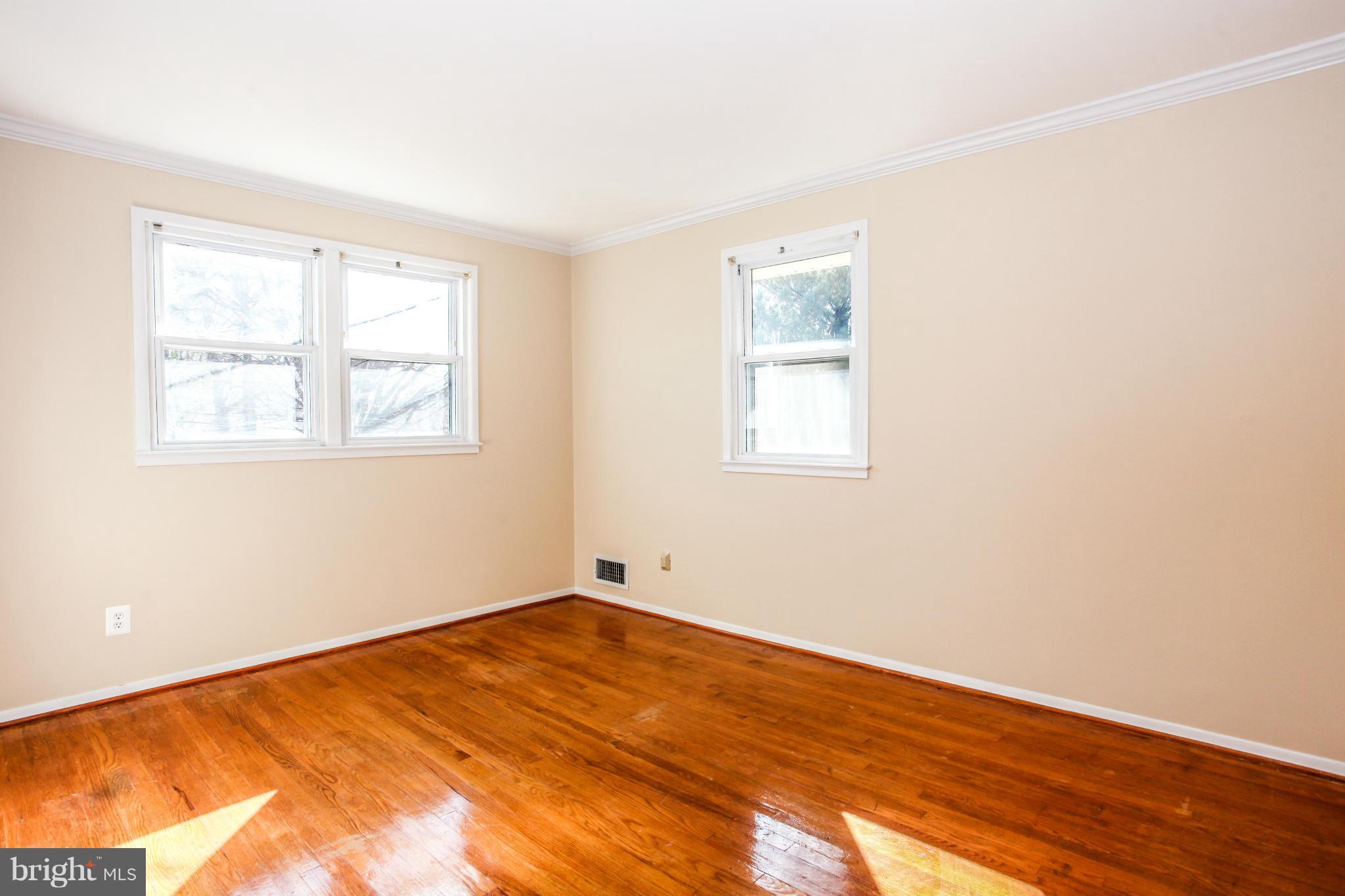 7620 Dunston Street Springfield, VA 22151 - Photo 13 of 24 an empty room with wooden floor and windows