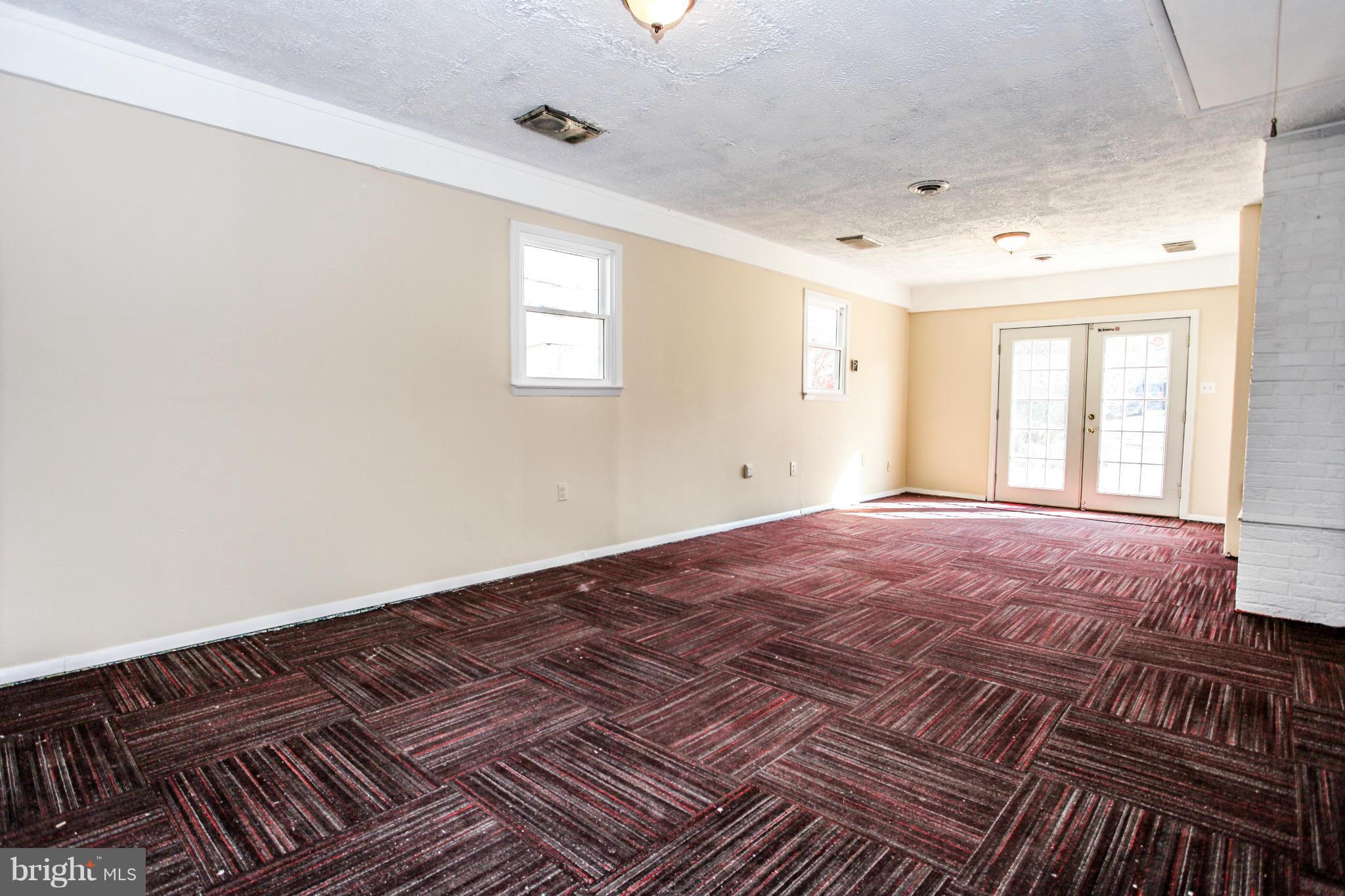 7620 Dunston Street Springfield, VA 22151 - Photo 18 of 24 a view of an empty room with window and wooden floor