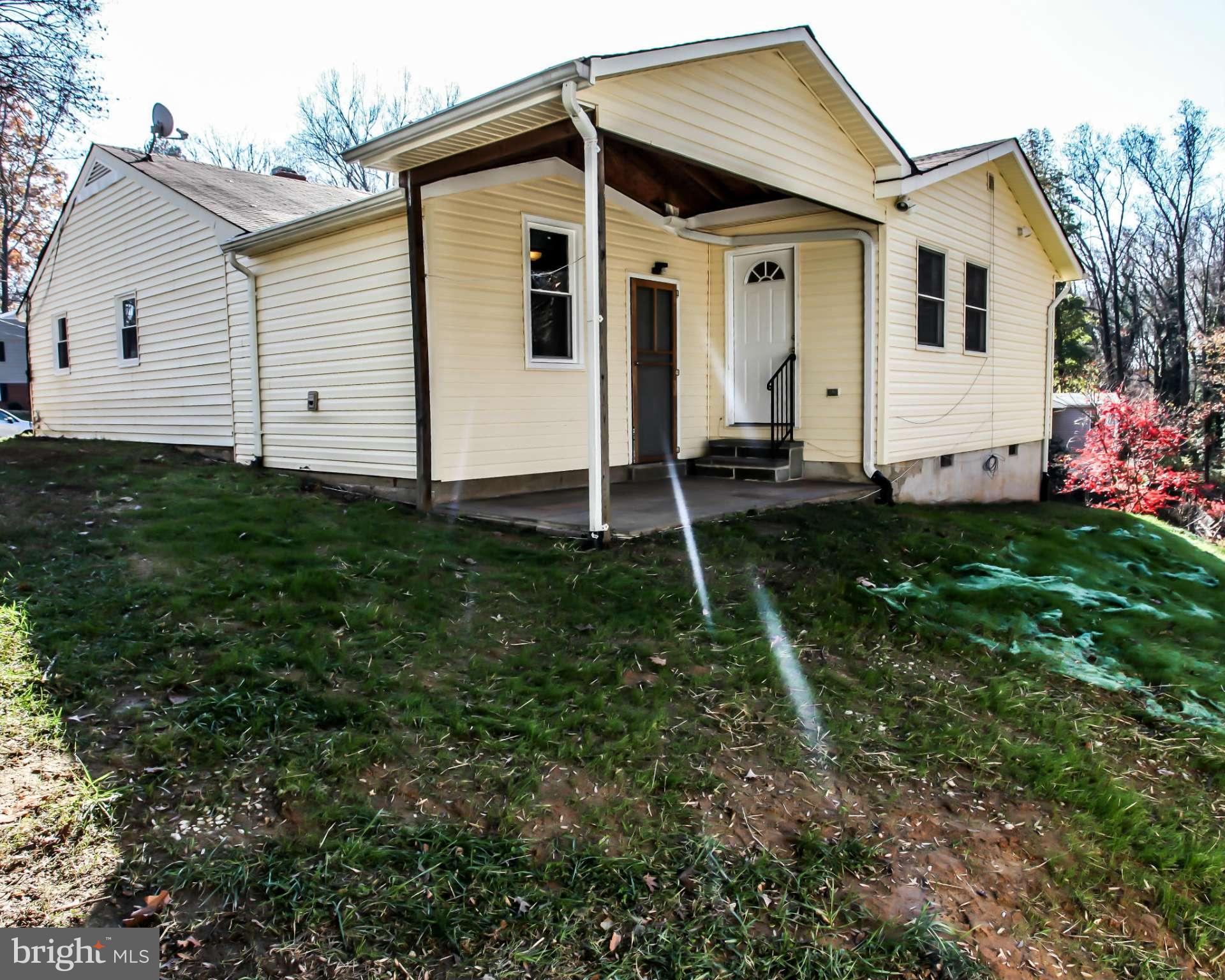 7620 Dunston Street Springfield, VA 22151 - Photo 22 of 24 a front view of a house with a yard