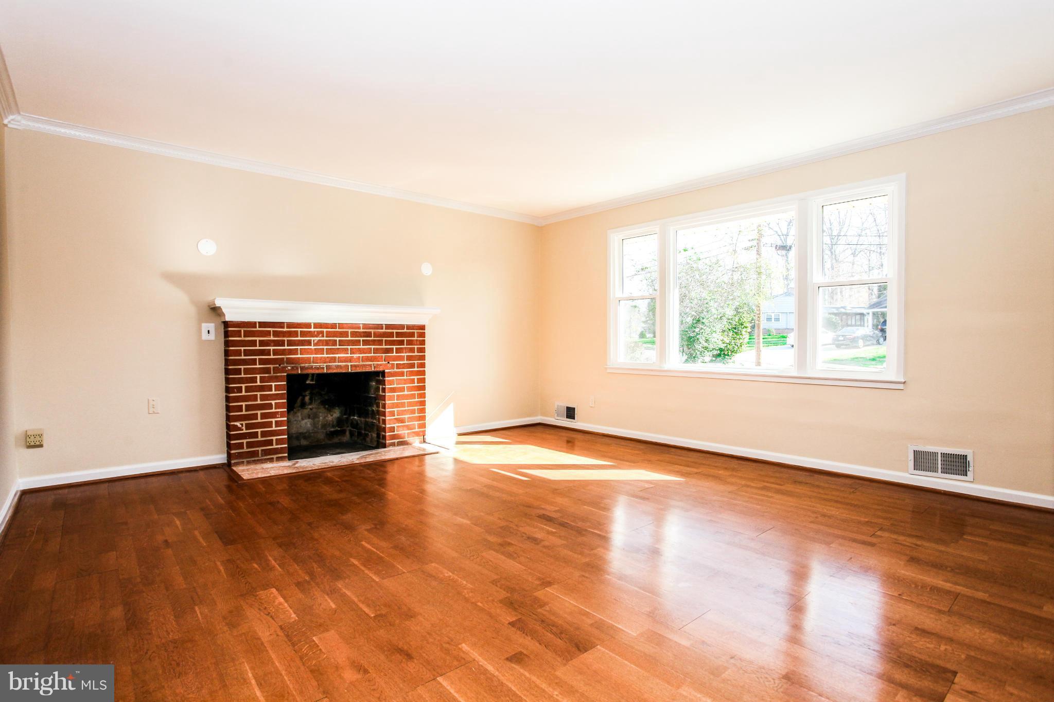 7620 Dunston Street Springfield, VA 22151 - Photo 3 of 24 an empty room with windows and fireplace