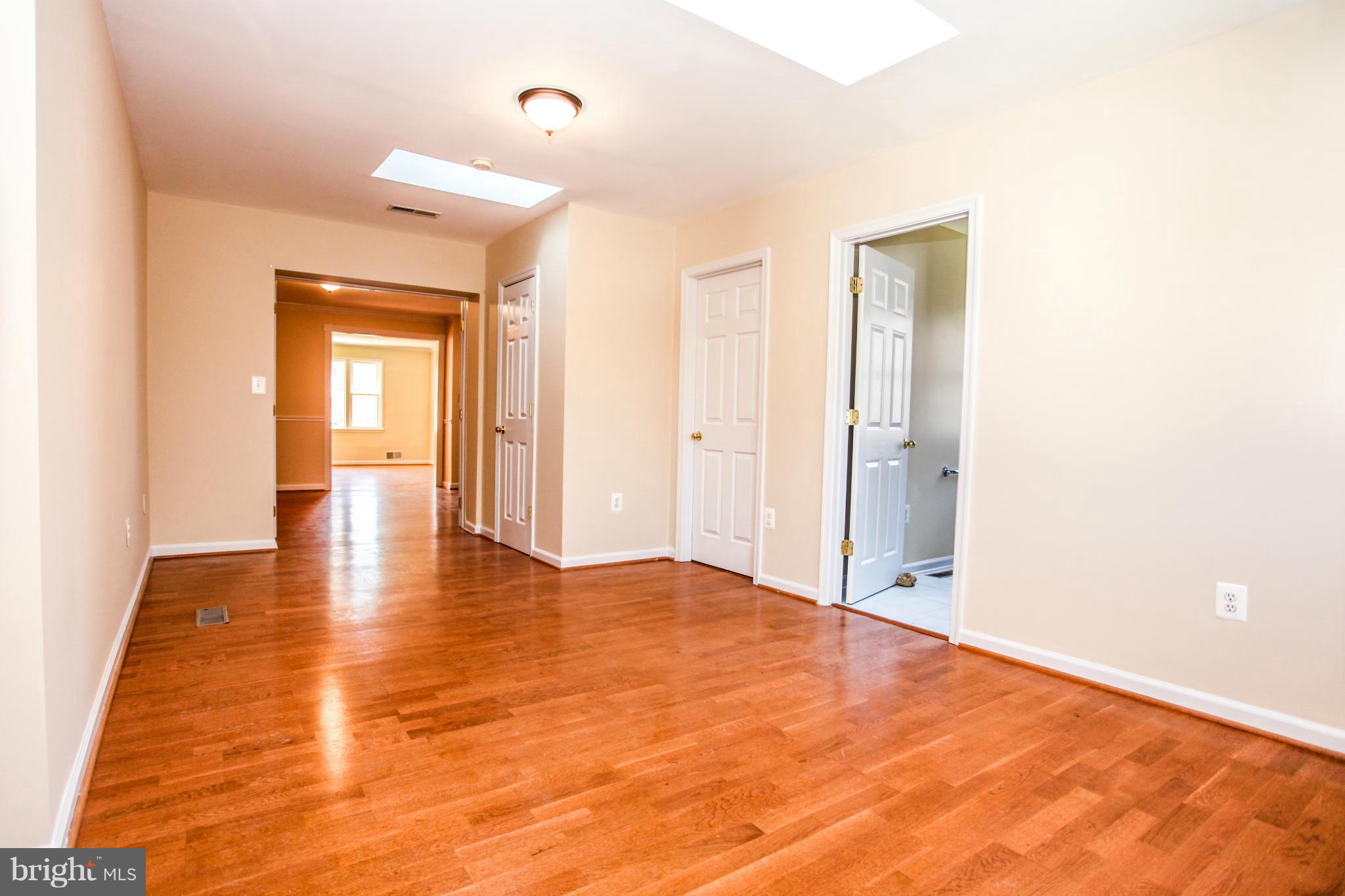 7620 Dunston Street Springfield, VA 22151 - Photo 8 of 24 a view of an empty room with wooden floor
