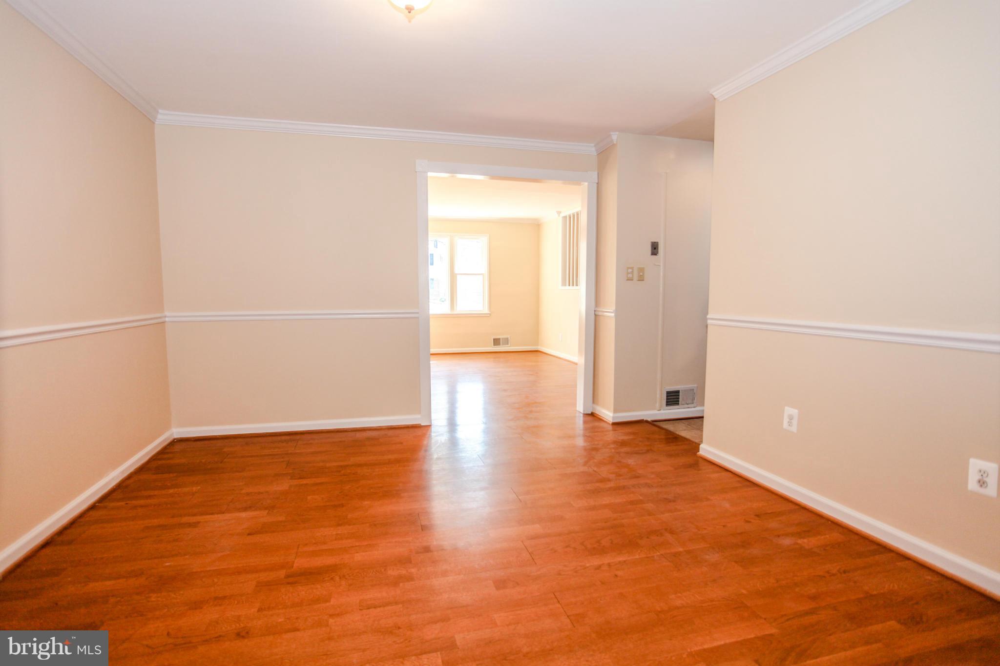7620 Dunston Street Springfield, VA 22151 - Photo 10 of 24 an empty room with wooden floor and a window
