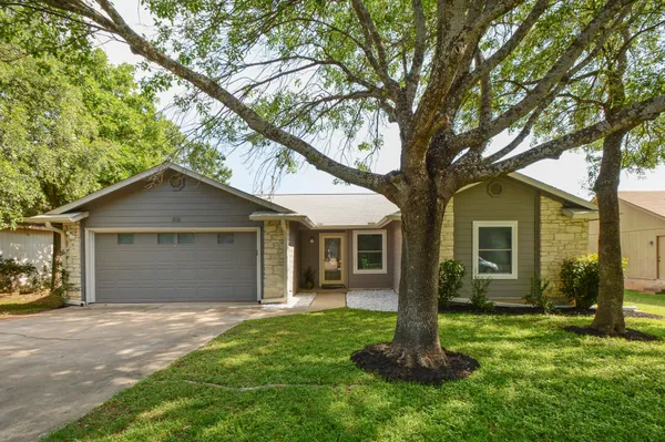 a front view of house with yard and green space