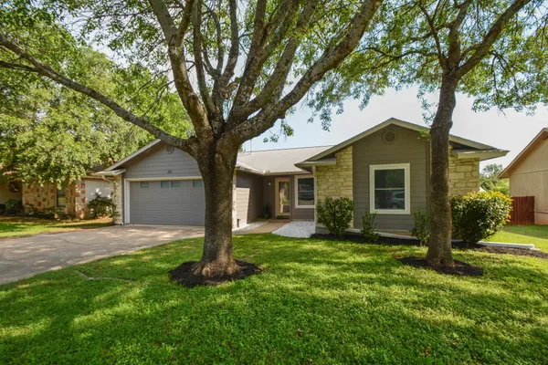 a front view of house with yard and green space