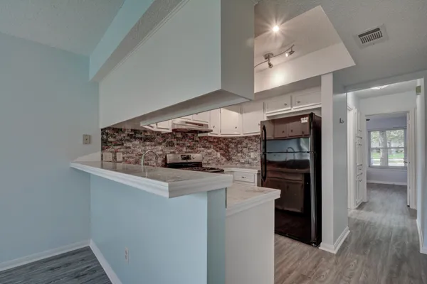 a kitchen with stainless steel appliances granite countertop a stove and a refrigerator