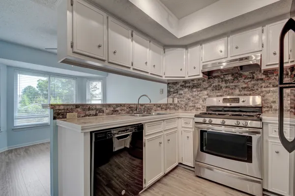 a kitchen with a stove top oven