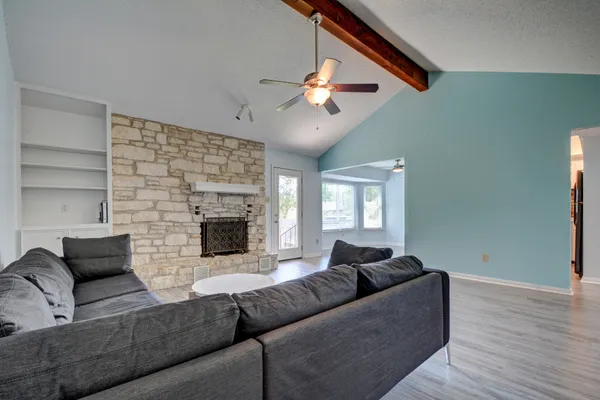 a living room with furniture and a fireplace