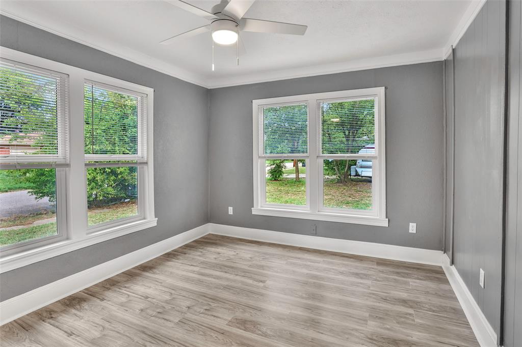 1005 North Neal Street Commerce, TX 75428 - Photo 15 of 23 a view of an empty room with wooden floor and a window