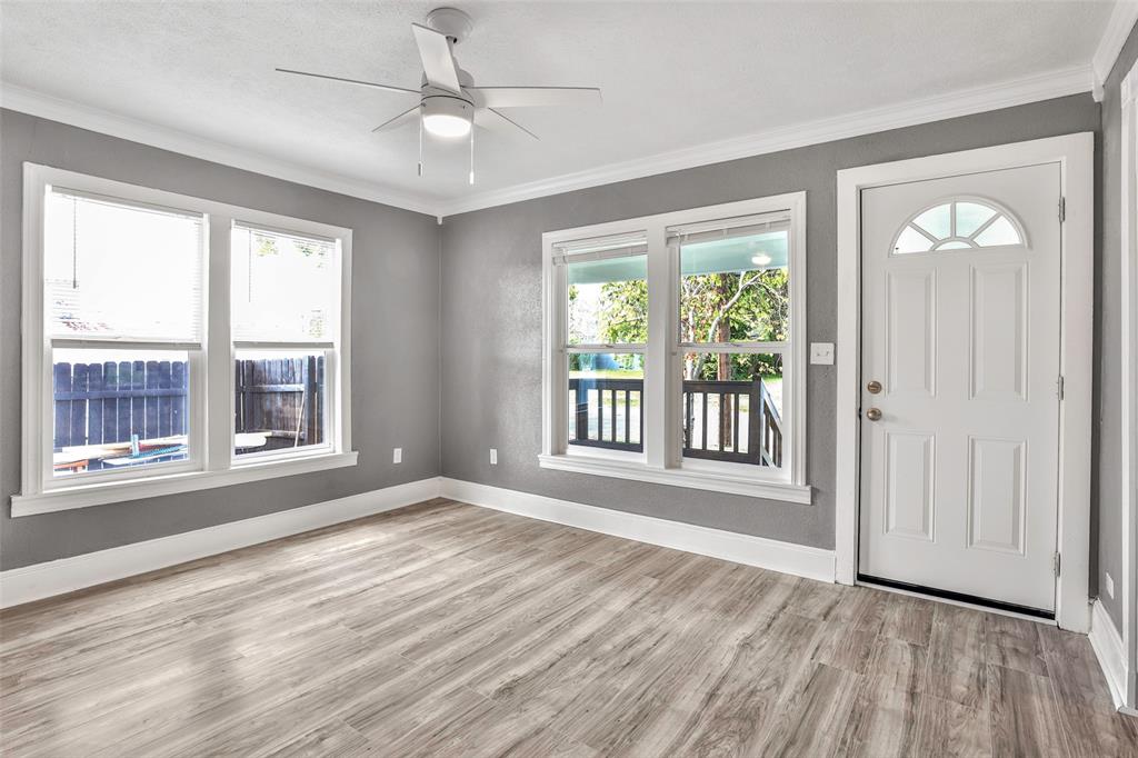 1005 North Neal Street Commerce, TX 75428 - Photo 5 of 23 a view of an empty room with a window and wooden floor