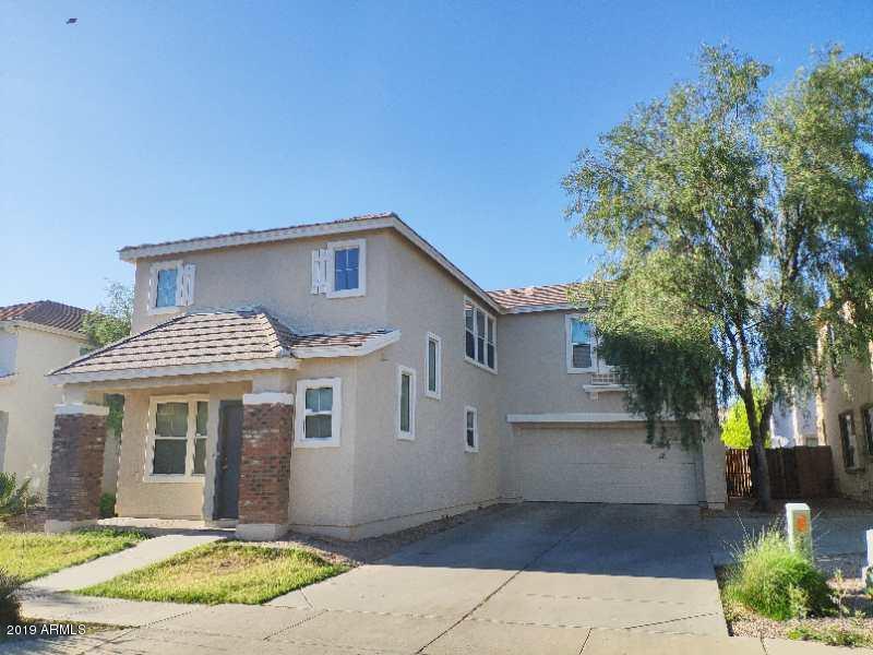 4006 West Carter Road Phoenix, AZ 85041 - Photo 1 of 12 a front view of a house with garden