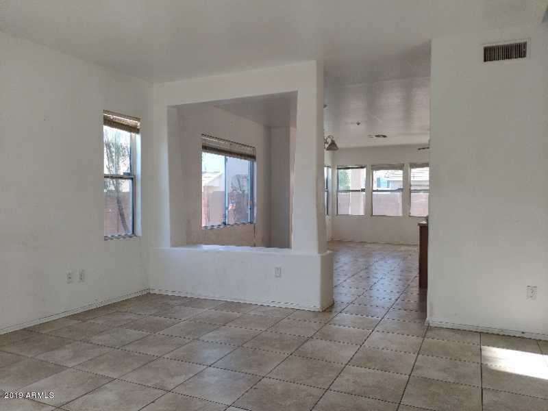 4006 West Carter Road Phoenix, AZ 85041 - Photo 3 of 12 an empty room with windows