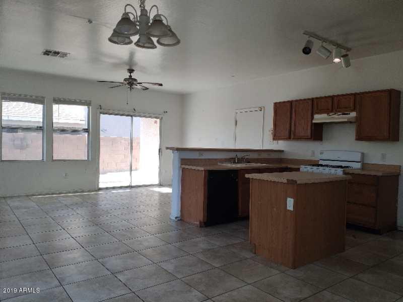 4006 West Carter Road Phoenix, AZ 85041 - Photo 4 of 12 a kitchen with stainless steel appliances granite countertop a stove a sink and a microwave