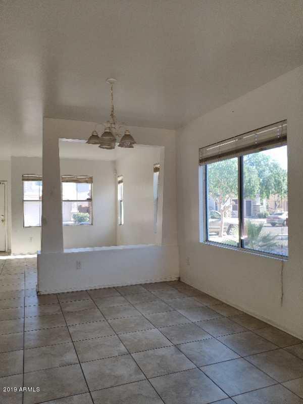 4006 West Carter Road Phoenix, AZ 85041 - Photo 6 of 12 wooden floor in an empty room with a window