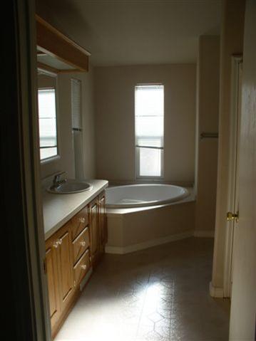 Master bathroom with Jack and Jill sinks and sunken bathtub.
