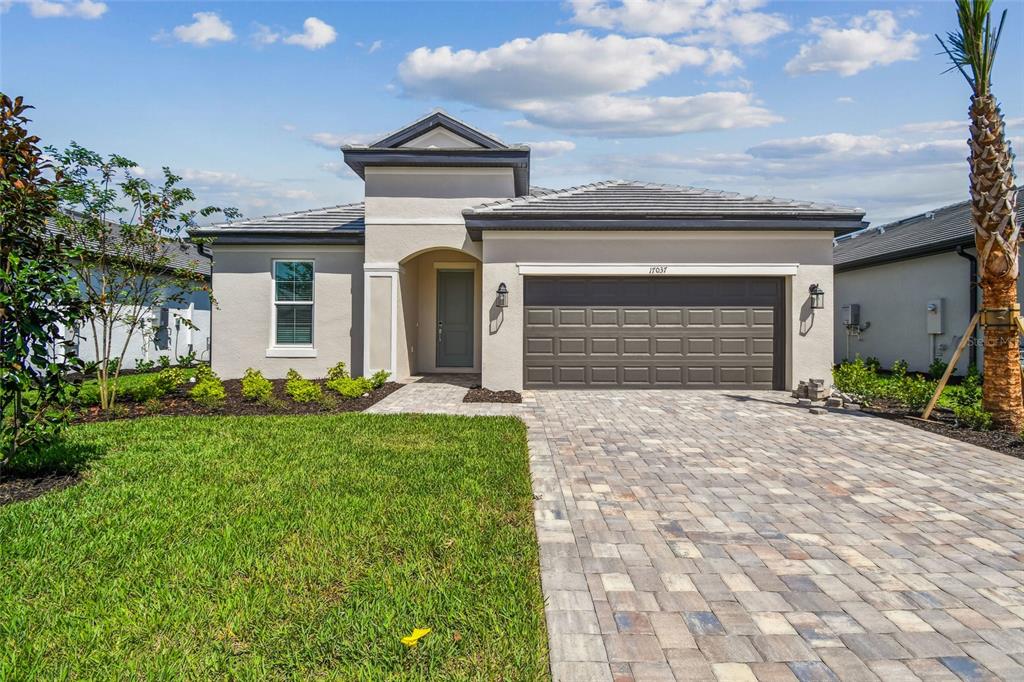17037 Savory Mist Circle Lakewood Ranch, FL 34211 - Photo 1 of 1 a front view of a house with a yard and garage