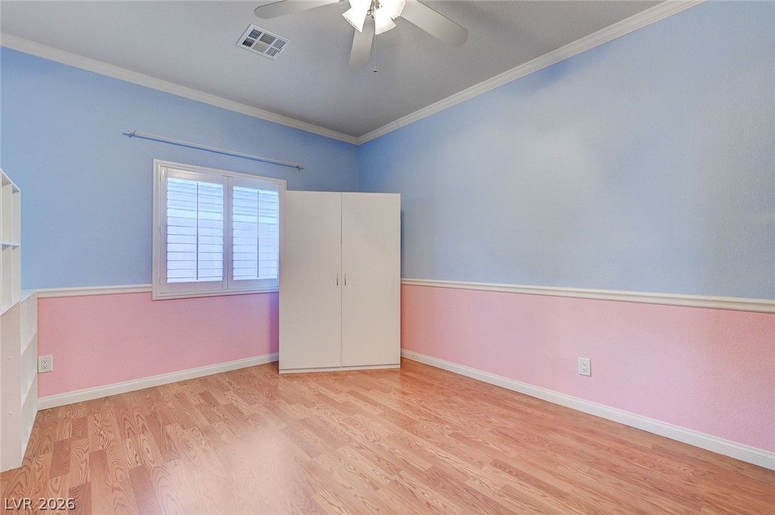 1604 Cattle Ranch Place Henderson, NV 89002 - Photo 58 of 99 A cheerful bedroom space features hardwood flooring and abundant natural light from the large window.