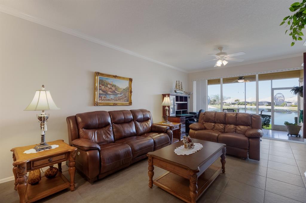 8414 Wethersfield Run, Unit 102 Lakewood Ranch, FL 34202 - Photo 13 of 48 a living room with furniture a rug and a lamp