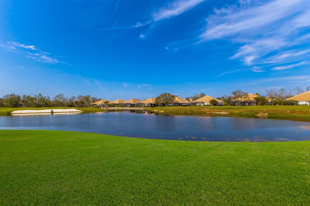 8414 Wethersfield Run, Unit 102 Lakewood Ranch, FL 34202 - Photo 28 of 48 a view of a lake with houses
